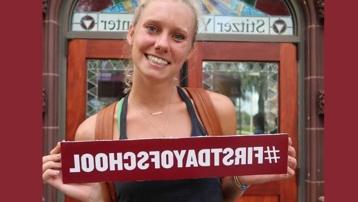 YMCA student posing with sign that says #FirstDayOfSchool